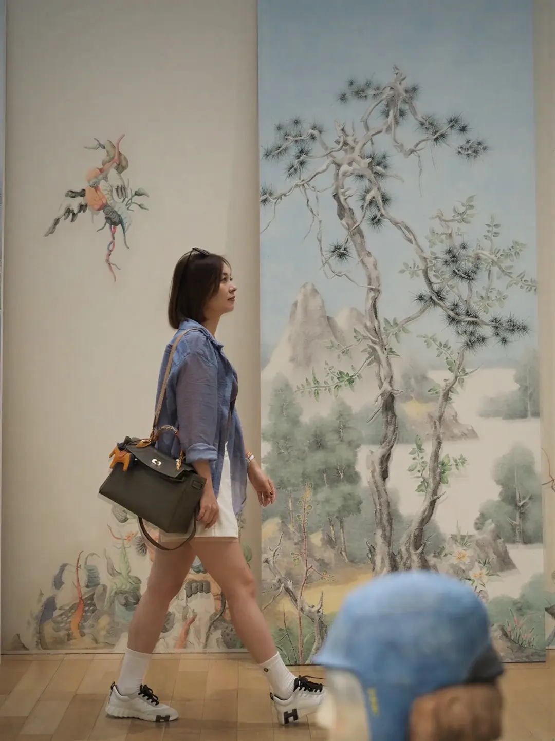 Alicia Dai walking through an art gallery